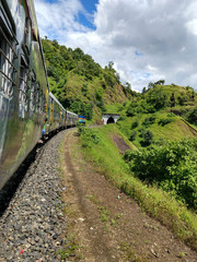 The train enters in a tunnel in hills, Indian Railway