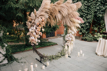 decor of the wedding ceremony area with fresh flowers and pampas grass