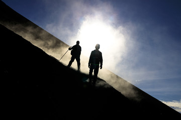 Two hikers descend from Fogo vulcano, Fogo Islands, Cape Verde