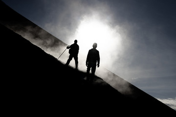 Two hikers descend from Fogo vulcano, Fogo Islands, Cape Verde