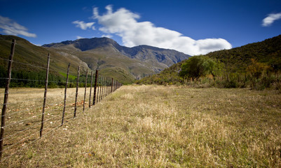 rural dirt road with mountains in background