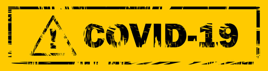 Yellow-black plate with the words Сovid-19 and a danger sign