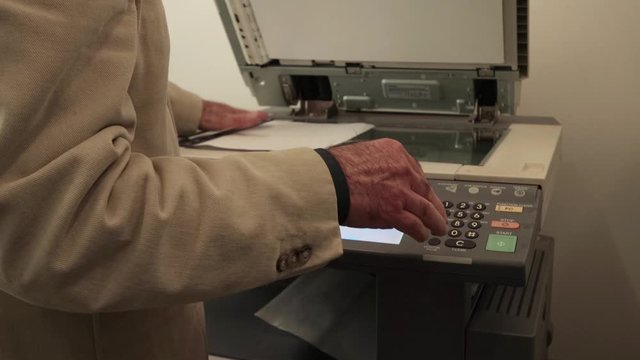 Man making copies with the copy machine in the office