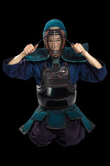 Portrait of man kendo fighter with shinai (bamboo sword). Shot in studio. Isolated with clipping...