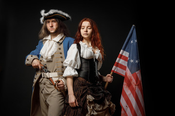 Man in form of officer of United States War of Independence and girl in historical dress of 18th...