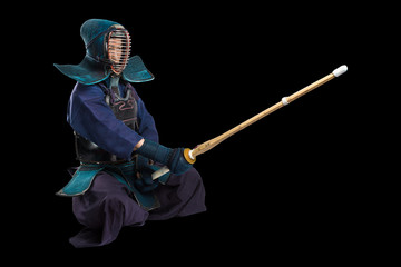 Portrait of man kendo fighter with shinai (bamboo sword). Shot in studio. Isolated with clipping path on black background