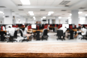 Empty wooden desk space over blurred office or meeting room background. Product display montage.