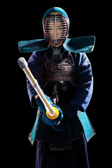 Portrait of man kendo fighter with shinai (bamboo sword). Shot in studio. Isolated with clipping...