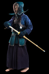 Portrait of man kendo fighter with shinai (bamboo sword). Shot in studio. Isolated with clipping...