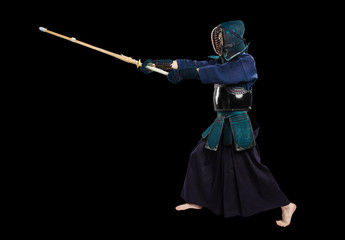 Portrait of man kendo fighter with shinai (bamboo sword). Shot in studio. Isolated with clipping path on black background