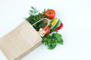 in a paper bag fresh vegetables on a white background