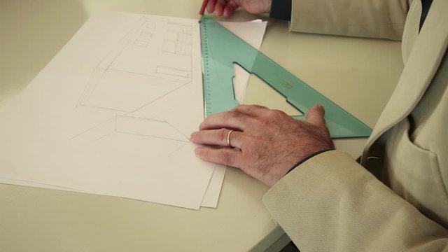 Man drawing with pencil and squares