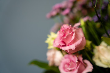 bouquet of red and pink flowers on a grey background