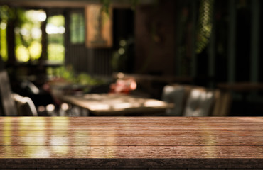 Empty old wood table top with bokeh coffee shop interior background