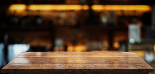 Empty old wood table top with bokeh coffee shop interior background
