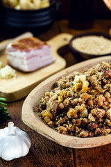 Beans with pork, called tropeiro beans in Brazil, typical Brazilian food, with ingredients, vegetables and vegetables in the background. Brazilian cuisine.