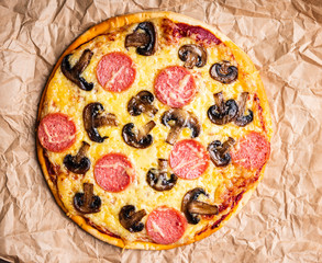 Freshly making pizza with mushrooms served on the rustic background. Selective focus. Shallow depth...