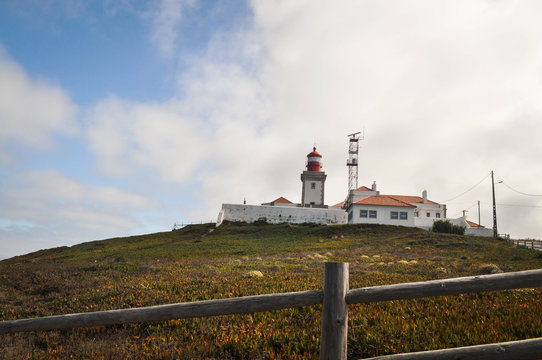 view of the lighthouse which stands cliffs over the ocean.  westernmost point of the europe