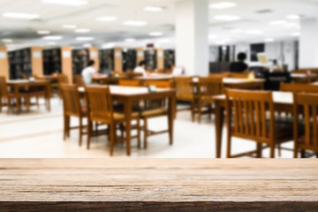 Wooden desk space over blurred office or meeting room background. Product display montage.