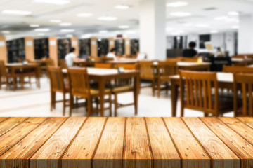 Wooden desk space over blurred office or meeting room background. Product display montage.