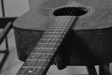 old guitar and broken string in home