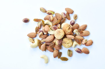 mixed nuts and dry raisin with fig on white background