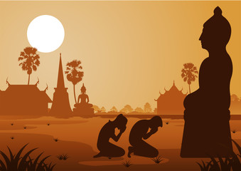 Naklejka premium Buddhist woman and man pay respect to buddha sculpture politely with faith and belief