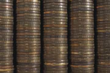 Background or wall from piles and edges of yellow brass coins close-up. 10 ten Russian rubles. Dark textured backdrop or wallpaper for economic, banking, financial, monetary topics. Macro