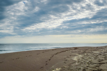 Footprint on the sand, empty beach with dramatic sky - adriatic sea in northern Italy