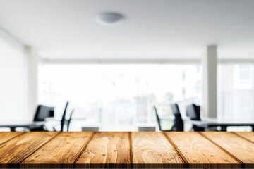 Desk space over blurred office or meeting room background. Product display.