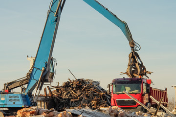 construction, loading debris onto a truck
