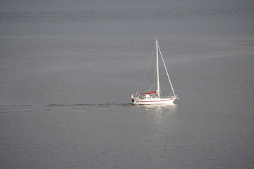A fjord in Norway and a small boat sailing in.