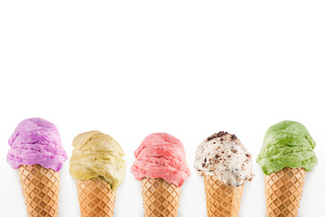 Ice cream cones with different flavors on white background with copy space