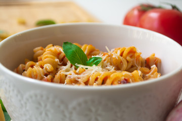 Italian pasta fusilli with fresh and spicy tomato sauce, Parmesan cheese and basil with ingredients...