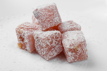 Turkish delight cubes with coconut flakes isolated on white background. Turkish sweets