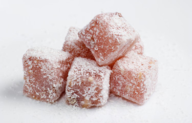 Turkish delight cubes with coconut flakes isolated on white background. Turkish sweets