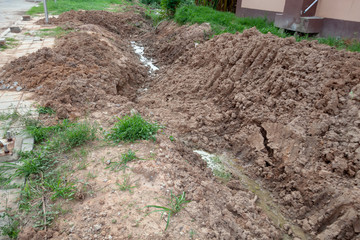 Concrete drain hole and water canal in construction site The reinstallation of drainage systems supports the growth of urban communities.