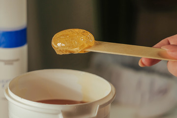 paste for shugaring on a spatula. selective focus