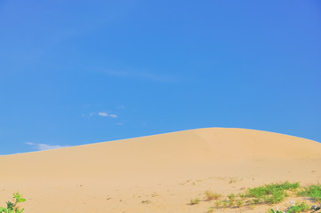 Scenic view of sand dunes under sunny blue cloud sky in Nam Cuong, Phan Rang, Viet Nam