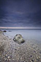 Sand plains with shells and large boulders at low tide. The Wadden Sea near Moddergat, Paesens, the Netherlands. UNESCO World Heritage, selective focus