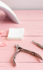 tool for manicure on a pink background. studio shot