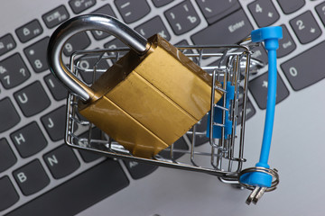 Shopping trolley with lock on keyboard. Hiding and protecting digital information, shopping