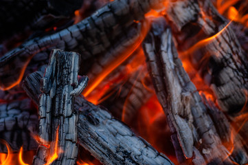 Flaming bright charcoal close-up for background.