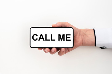 CALL ME text on white screen of a phone in a male hand isolated on white background