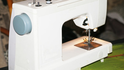 white sewing machine on the work table