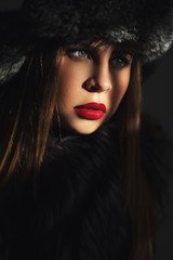 Portrait of a beautiful girl in a fur hat