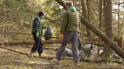 Eco volunteers collecting garbage in the forest