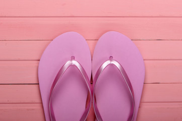 Flip Flops on a pink wooden background. Top view