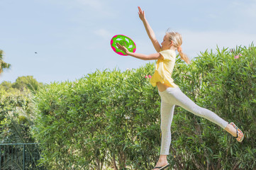 Girl playing Frisbee in the garden, Summertie fun