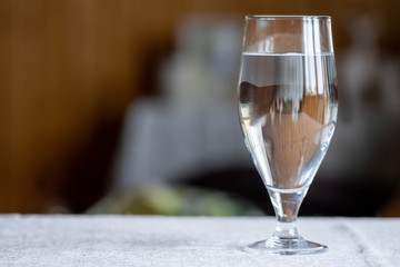 transparent decanter with a beautiful crystal glass on a dark background. glass of water